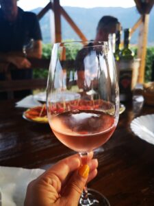 Glass of rose wine in vineyard shed during wine tasting experience